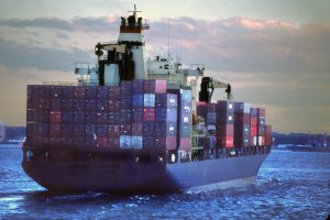 A loaded container ship leaves the port of New York at dusk.
new york port container ship loaded fully full dusk outward bound ocean pacific maritime shipping transportation water laden
